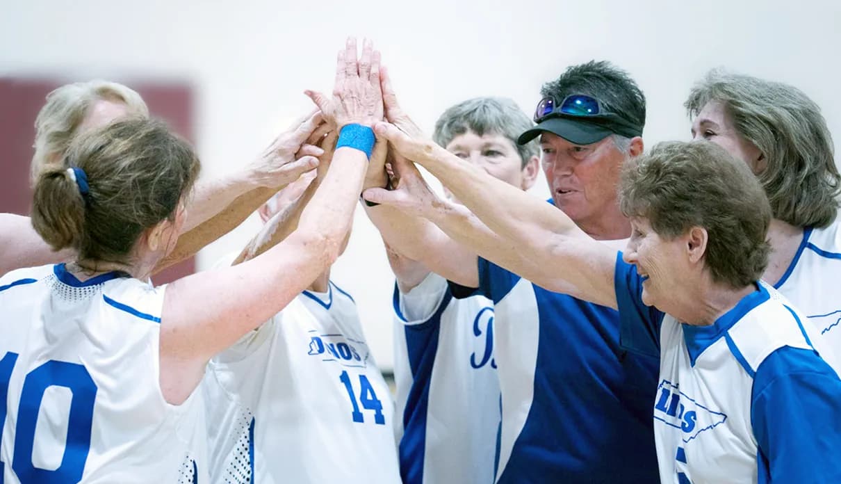 A team celebrating with a group high five.
